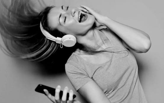 Person wearing headphones against geometric pattern