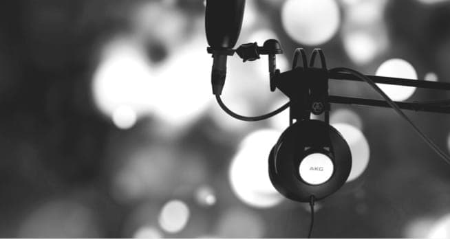 Person wearing headphones against geometric pattern