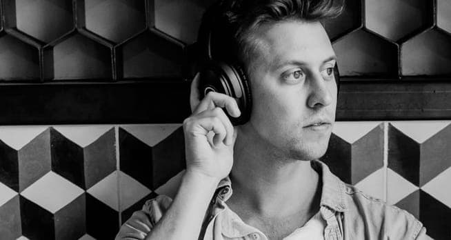 Person wearing headphones against geometric pattern