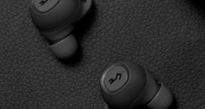 Person wearing headphones against geometric pattern